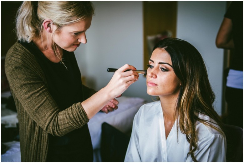 bride and bridesmaid getting ready for the wedding