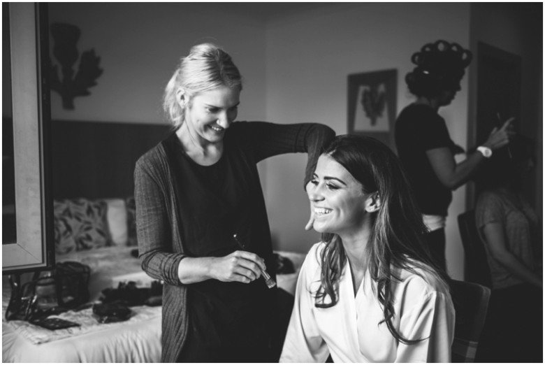 bride and bridesmaid getting ready for the wedding