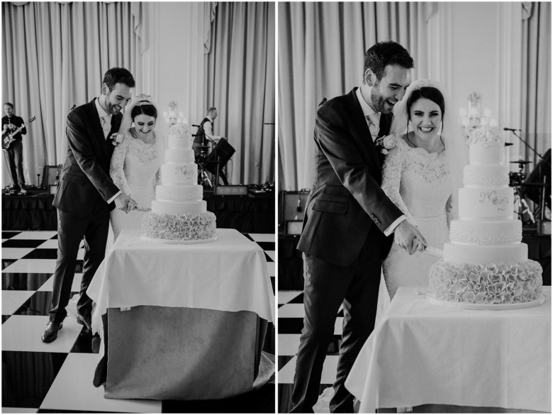 bride and groom cutting their wedding cake