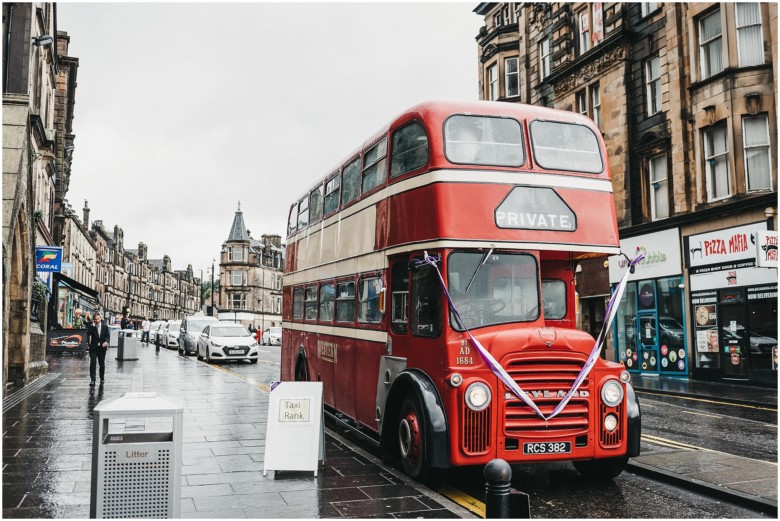 wedding guests arriving on an old london bus