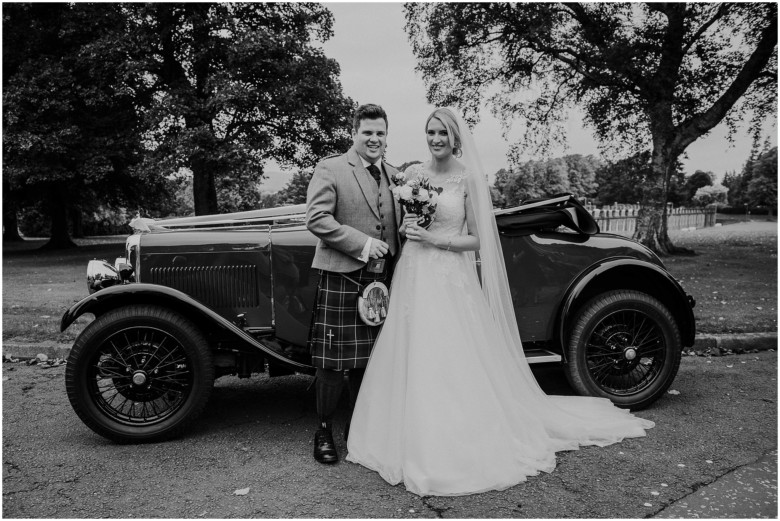 bride and groom with a vintage car
