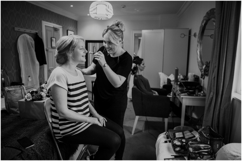 bride and bridesmaid getting ready 