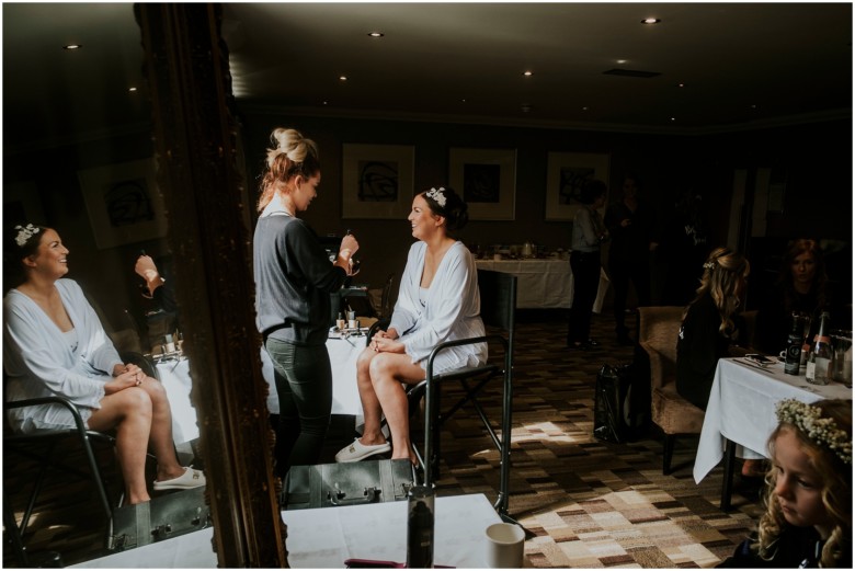 bride and her bridesmaids getting ready