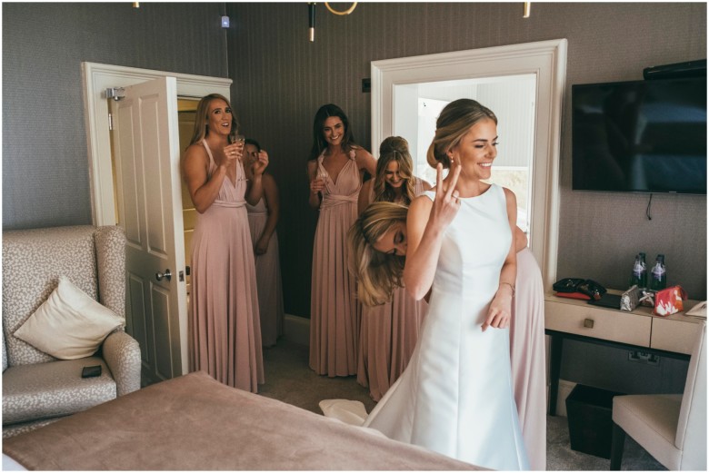 bride and her bridesmaids getting ready for the wedding