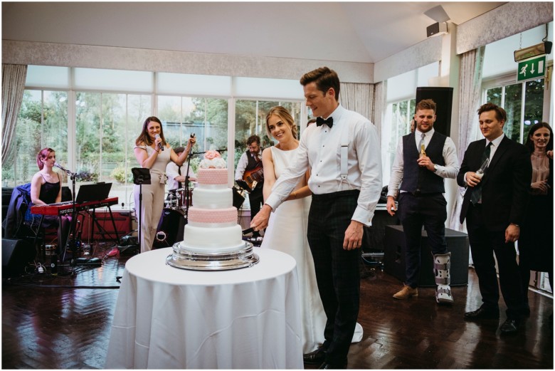 bride and groom cutting the cake