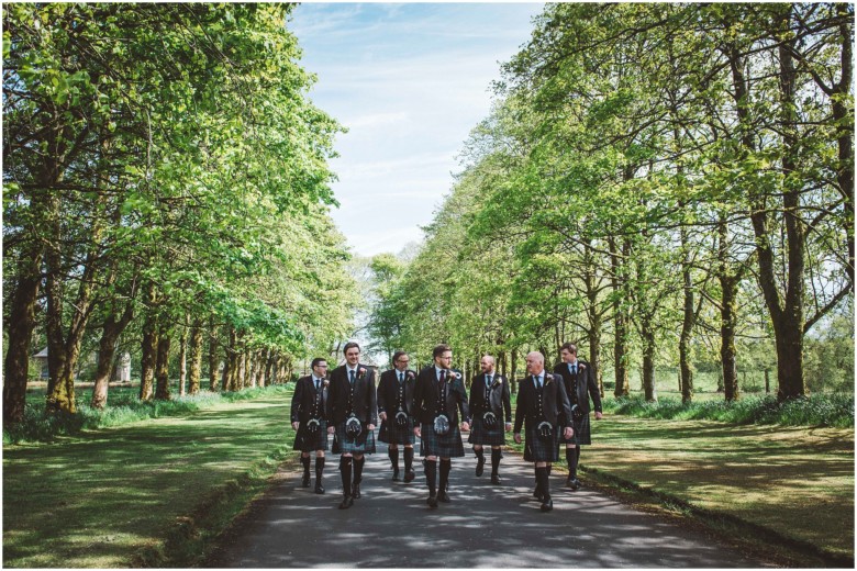 groom and his groomsmen getting ready for the wedding