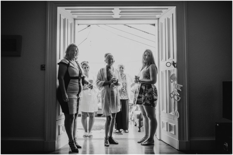 bride and her bridesmaids getting ready for her wedding