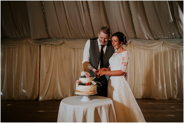 bride and groom cutting the cake