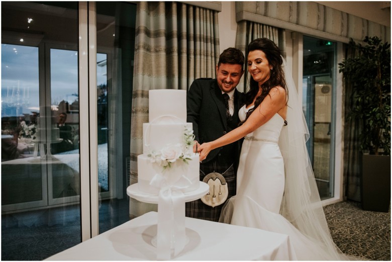 cutting their wedding cake