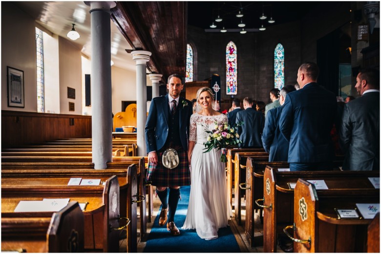 bride and groom leaving the church