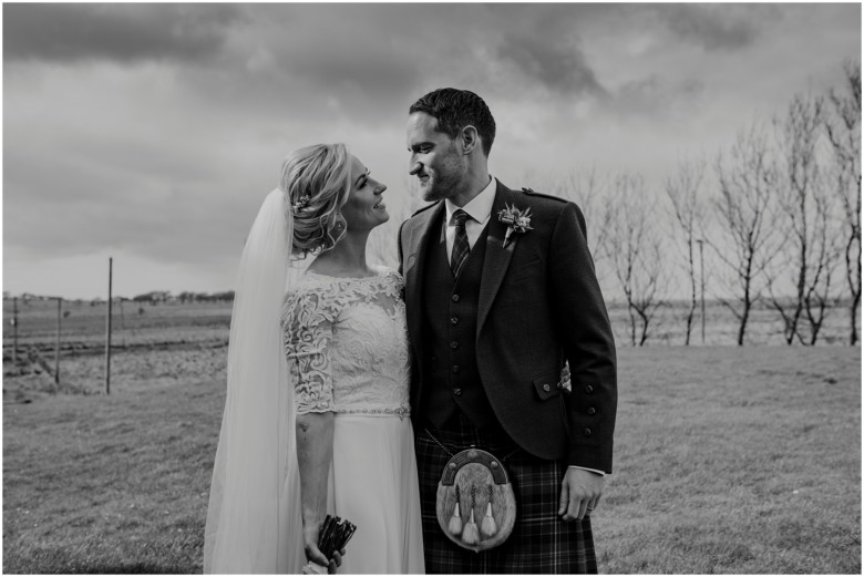 bride and groom at their rustic barn wedding