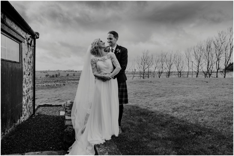 bride and groom at their rustic barn wedding