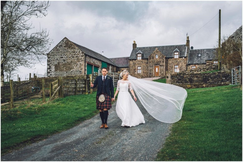 bride and groom at their rustic barn wedding