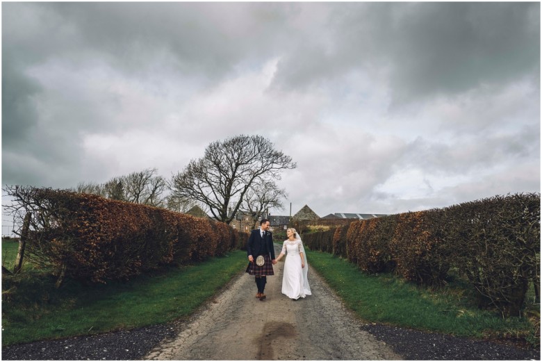 bride and groom at their rustic barn wedding