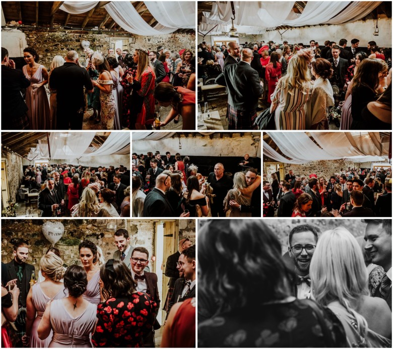 wedding guests at drinks reception in a rustic barn