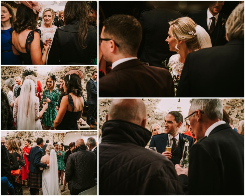 wedding guests at drinks reception in a rustic barn