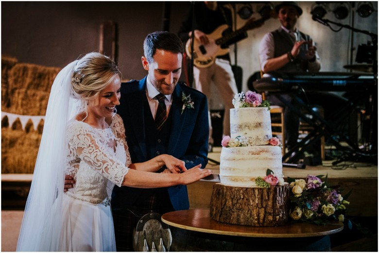 bride and groom cutting the cake