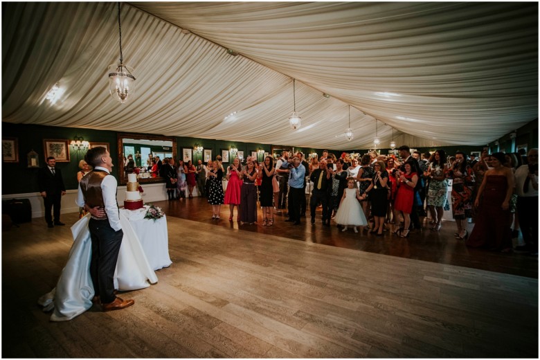 bride and groom cutting the cake