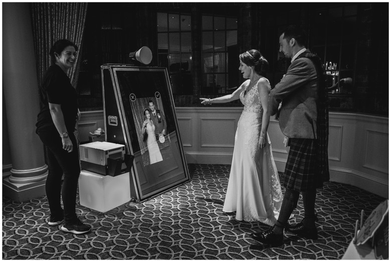 bride and grooms at photo booth